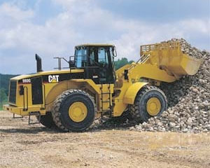 Caterpillar® wheel loader / rubber tire loader scoops up a load of rip rap