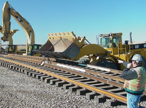 Caterpillar® wheel loader / rubber tire loader works with excavators to move a stretch of track.