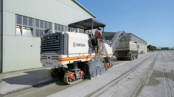 Milling off a concrete surface on company premises.