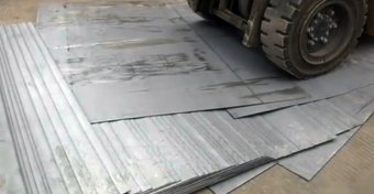 The forklift was trying to pick up a stack of 52 iron sheets when it began to tip over