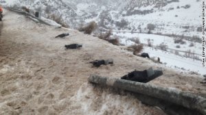 The plow burst through the guardrail after being hit.