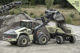 Volvo CE's LX1 loader delivers a payload to the HX1, an autonomous hauler. Both machines were unveiled at the company's Xploration Forum.